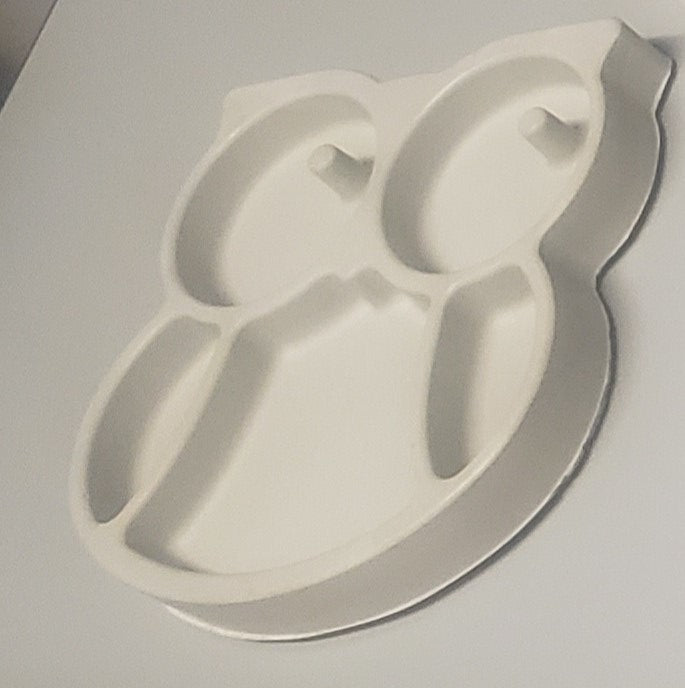 Metallic key-shaped object on a light gray background