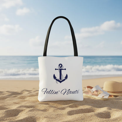 A white canvas tote bag with black shoulder straps, featuring a navy blue anchor graphic and the script text 'Fellin' Nauti' printed on the front, set against a plain white background.