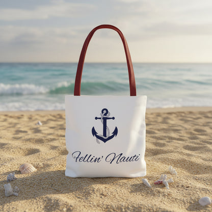 A white canvas tote bag with dark red shoulder straps, featuring a navy blue anchor graphic and the script text 'Fellin' Nauti' printed on the front, set against a plain white background.