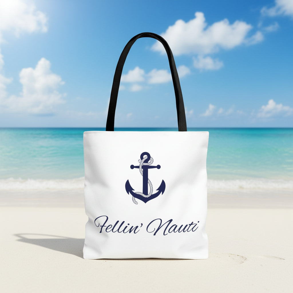 A white canvas tote bag with black shoulder straps, featuring a navy blue anchor graphic and the script text 'Fellin' Nauti' printed on the front, set against a plain white background.