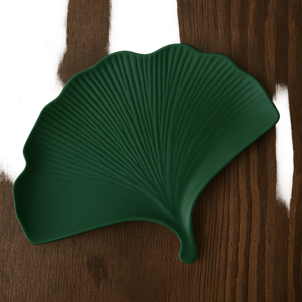Green leaf-shaped object on a wooden surface