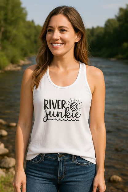 Woman wearing a 'River Junkie' tank top by a river with trees in the background