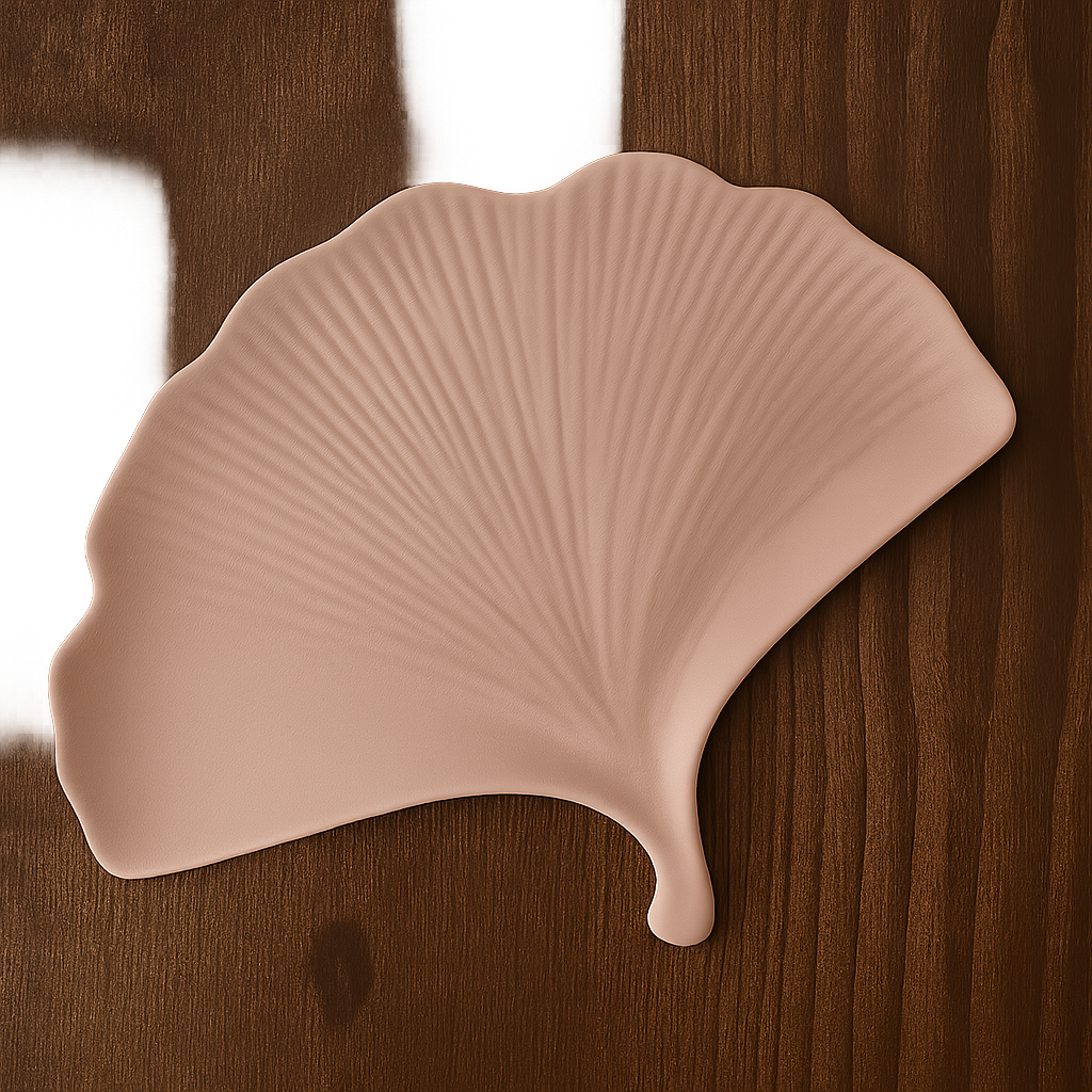 Pink leaf-shaped object on a wooden surface