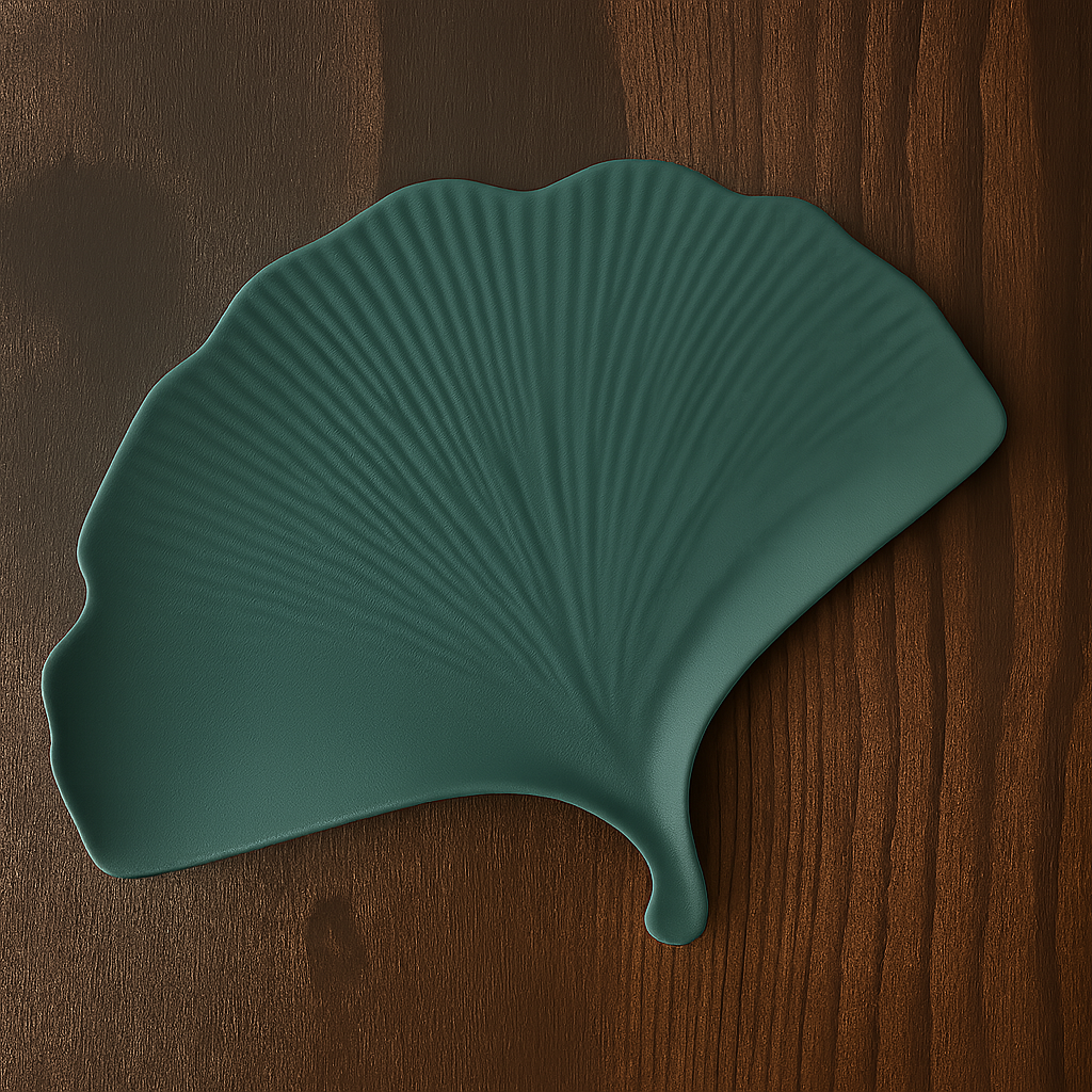 Teal leaf-shaped placemat on a wooden surface