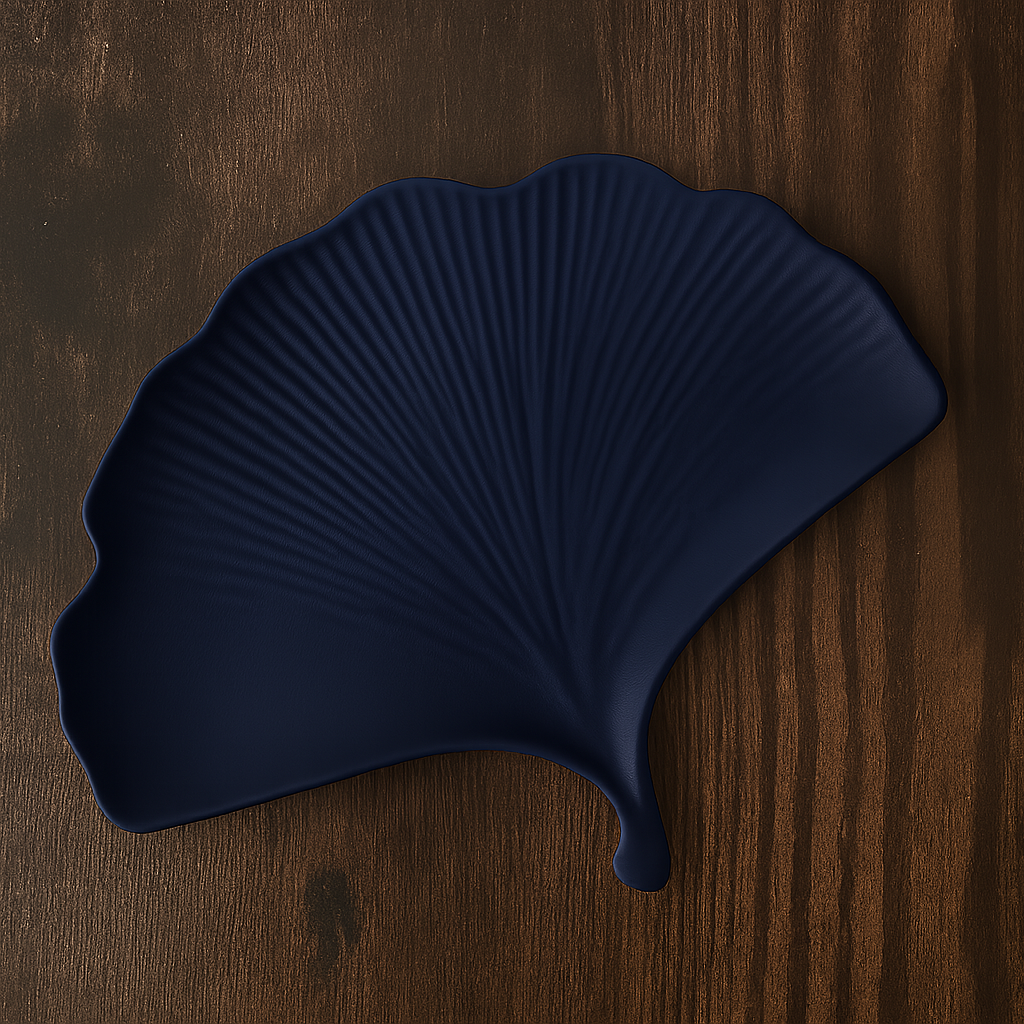 Navy blue leaf-shaped tray on a wooden surface