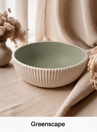 A cement bowl with a ribbed fluted exterior and a muted sage green interior, styled on a beige fabric surface with dried flowers and draped curtains in the background. The word 'Greenscape' appears in a black text box at the bottom.