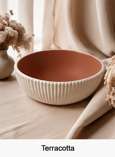 A cement bowl with a textured, ribbed cream exterior and a matte terracotta-colored interior, styled on a beige fabric surface with dried flowers in the background. The word 'Terracotta' is printed at the bottom.