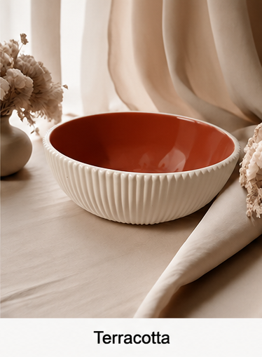 A ribbed cement bowl with a terracotta orange interior and an off-white exterior, styled on a beige fabric surface with dried flowers and draped curtains in the background. The word 'Terracotta' is printed at the bottom.