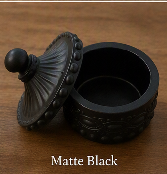 Matte black decorative round box with a matching lid, shown on a wooden surface with the text 'Matte Black' below.