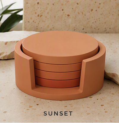 A terracotta-colored cement coaster set with a matching circular lid, displayed on a speckled beige stone surface. The set is shown with the lid resting on top of the stacked coasters.